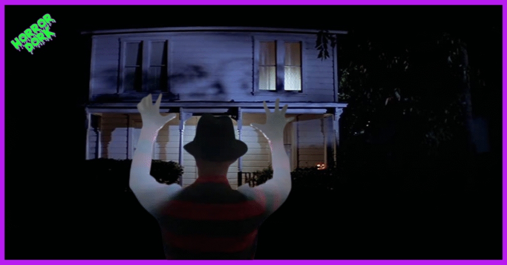 Freddy Krueger facing the Myers house at night, symbolizing the clash between Nightmare on Elm Street and Halloween in 1980s horror.