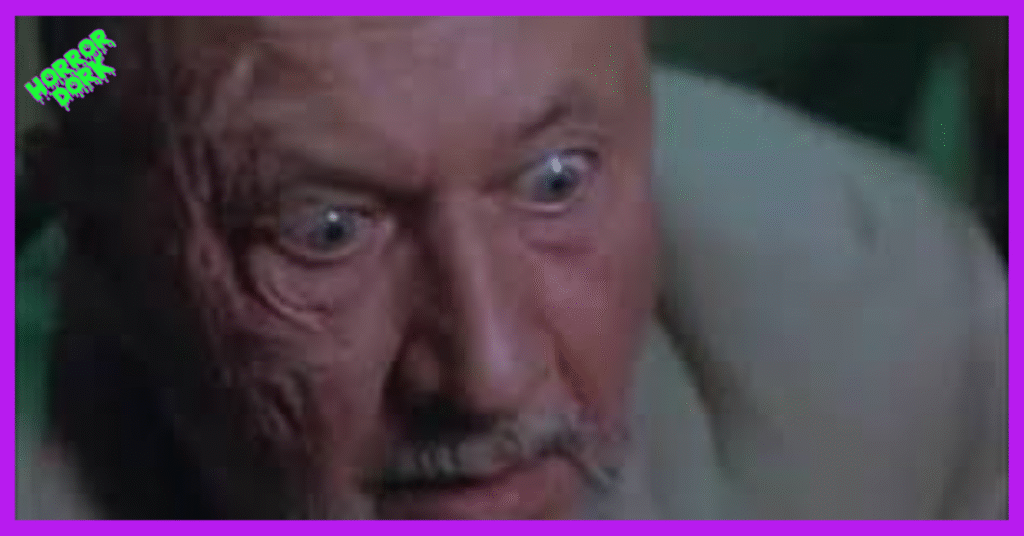 Close up of Dr. Loomis from Halloween with wide, frantic eyes, framed in Horror Dork’s purple border.