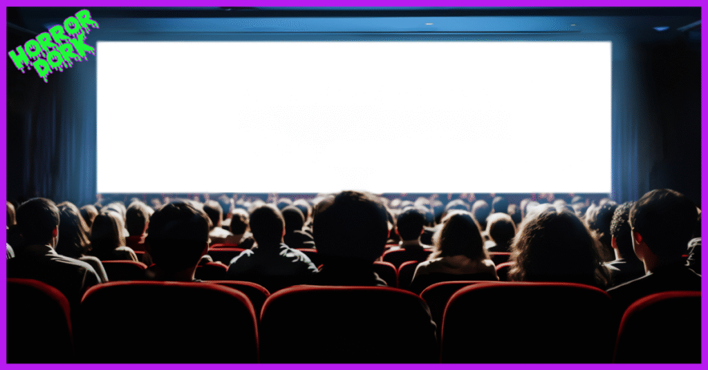 Audience sitting in a dark theater watching a bright movie screen with the Horror Dork logo in neon slime font.